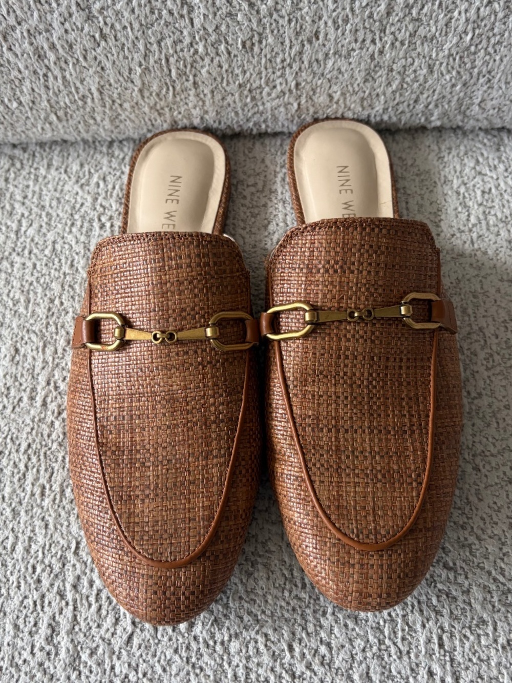 Nine West tan woven, slip-on mules with gold buckle.